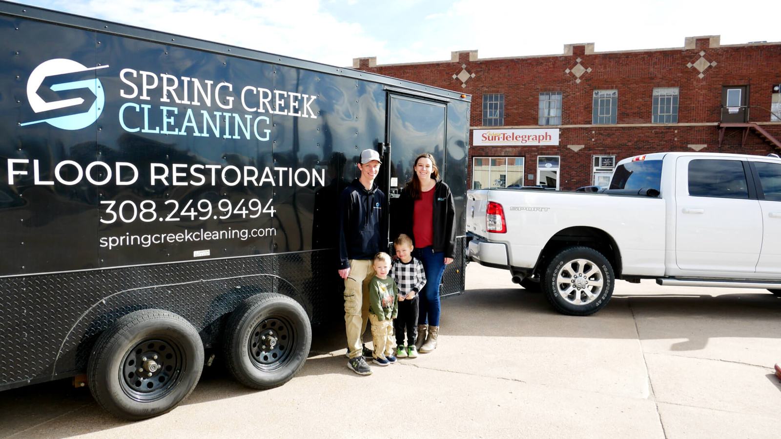 The Spring Creek family team beside their flood restoration trailer