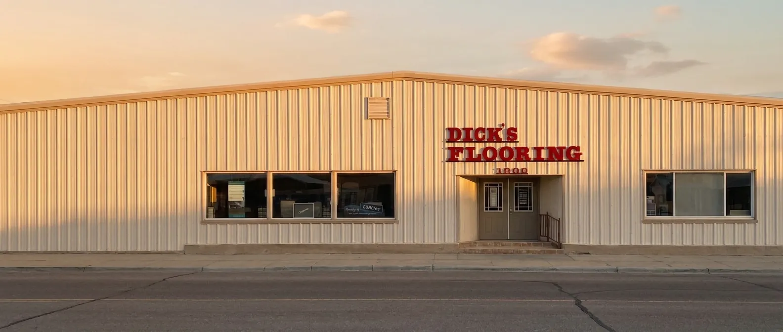 Dick's Flooring storefront at 1800 Illinois Street in Sidney, Nebraska, at golden hour
